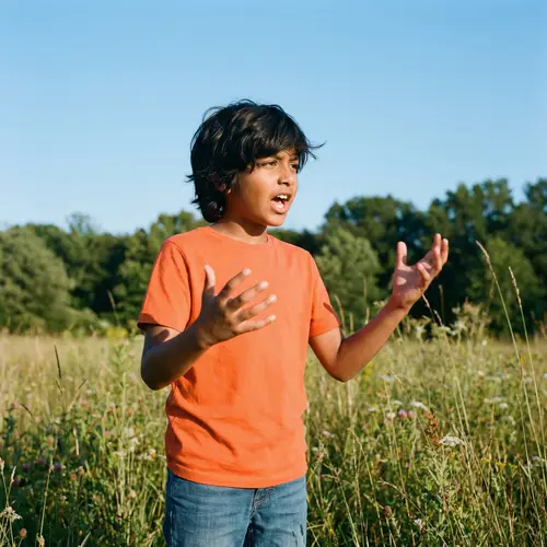 Passionate Young South Asian Boy Outdoors | Bright Orange Shirt, Blue Jeans