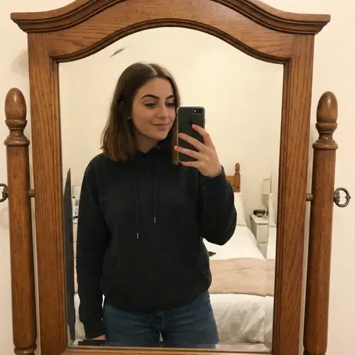 18-Year-Old Girl Taking a Mirror Selfie