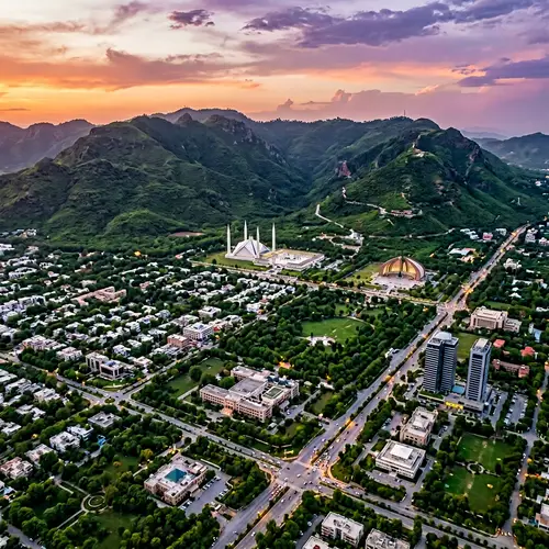 Picturesque Islamabad: Cityscape with Mountains & Serene Sunset