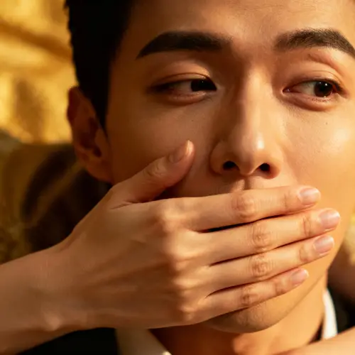 Intriguing Moment: A Woman's Hand Over a Man's Mouth