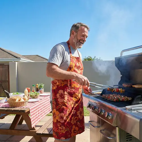 Cheerful Man Grilling Meat Outdoors - BBQ Relaxation Scenes
