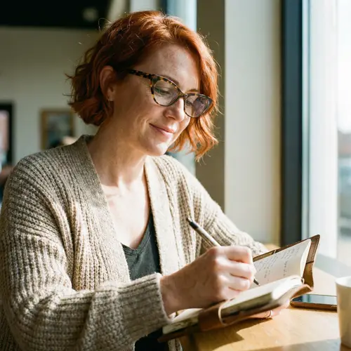 Charming Woman in Cat Eye Glasses Writing Notes